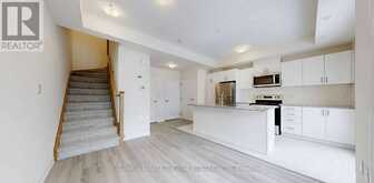 32 - 165 TAPSCOTT ROAD | Toronto Ontario | Slide Image Two